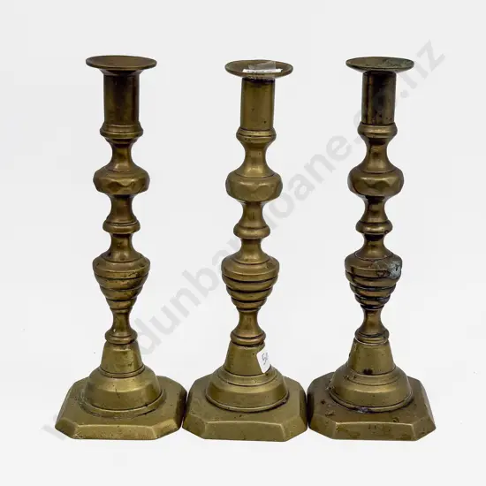 A Set of Three Brass Candlesticks