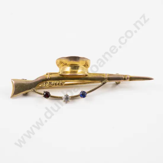 WWI Period 9ct Sweetheart Brooch of Rifle and Cap with Three Crystals Red White & Blue