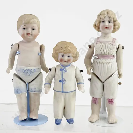 Three German and Japanese All Bisque dolls with Moulded Underwear and Pyjamas