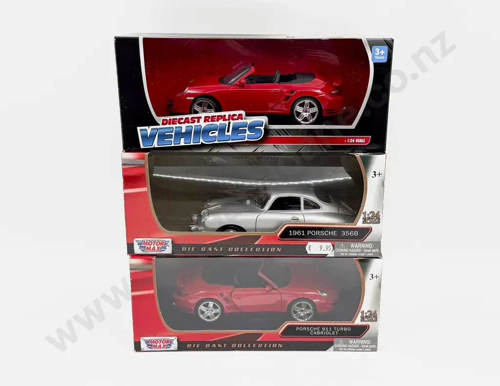 Three Boxed 1:24 Scale Porsche Models Image 1++