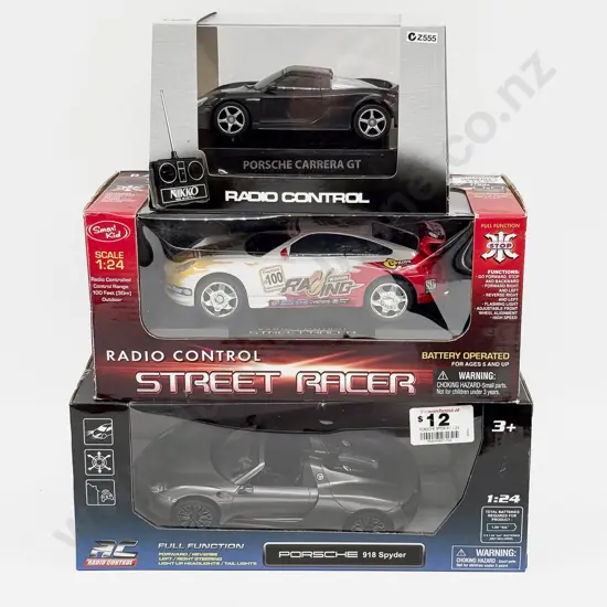 Two Boxed Radio Control1:24 Scale Porsche Models and One Nikko 1:32 Scale Porsche Model