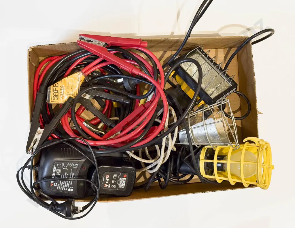Box of Assorted Including Black and Decker Battery Charger and Battery With Jumper Cables and Work Lights Image 1++