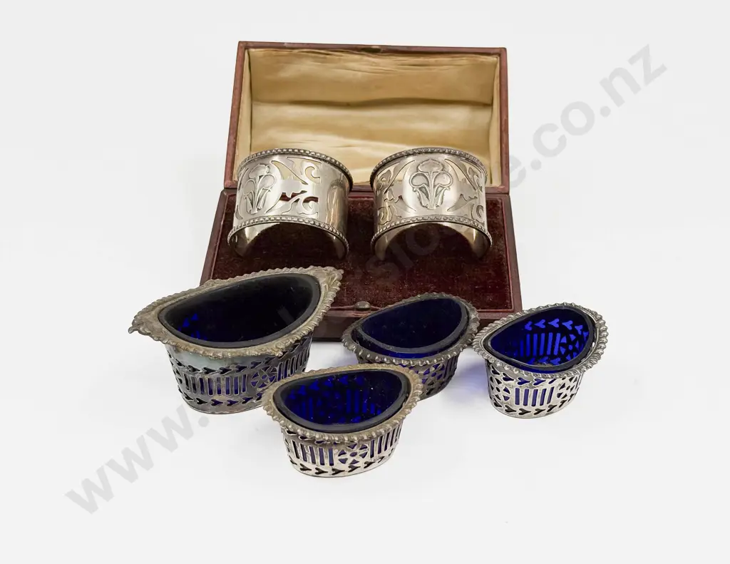 Cased Pair of S/S Napkin Rings with Four Pierced S/S Condiments with Blue Glass Inserts Image 1++