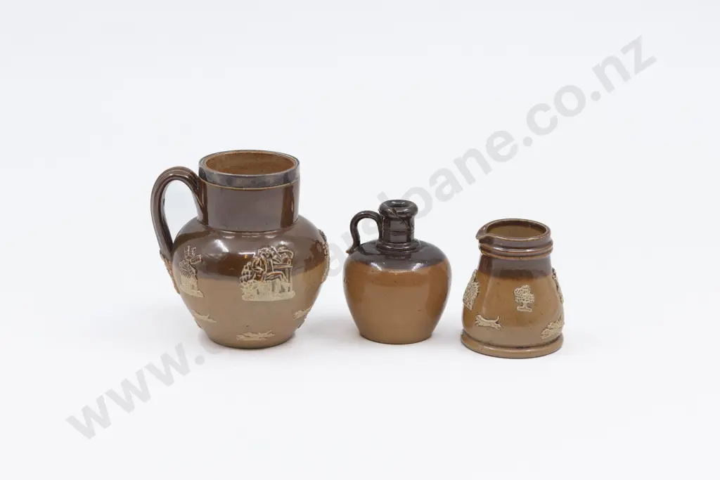 Three Doulton Stoneware Miniature Tavern Jugs with Applied Motifs Image 1++