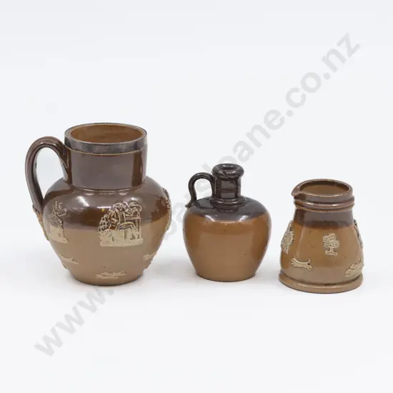 Three Doulton Stoneware Miniature Tavern Jugs with Applied Motifs