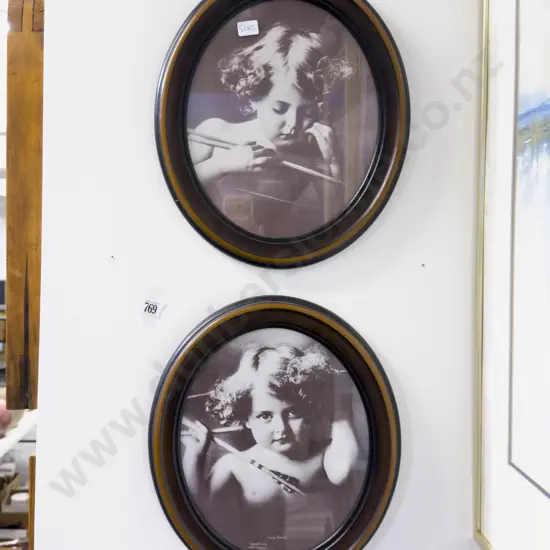 A Pair of Oval Framed Photographic Prints